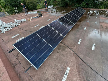 Some solar panels during installation on a flat roof