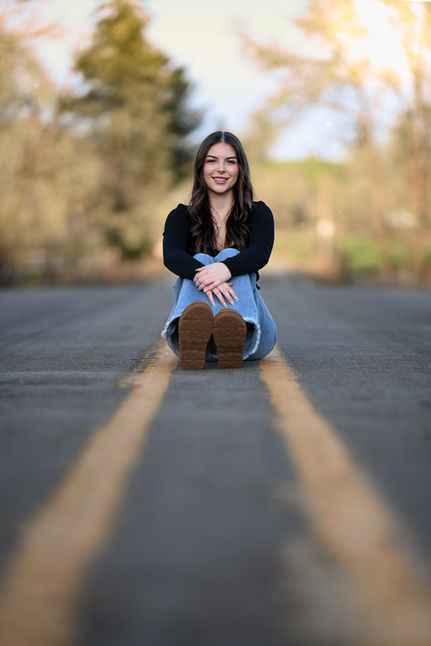 Senior in a casual outfit sitting | Fun senior photo shoot in Oregon