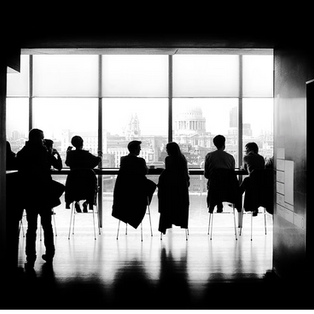 People sitting at a conference room table