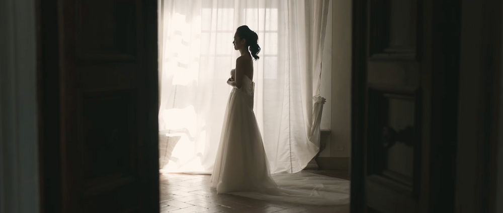 the bride getting ready in front of a window