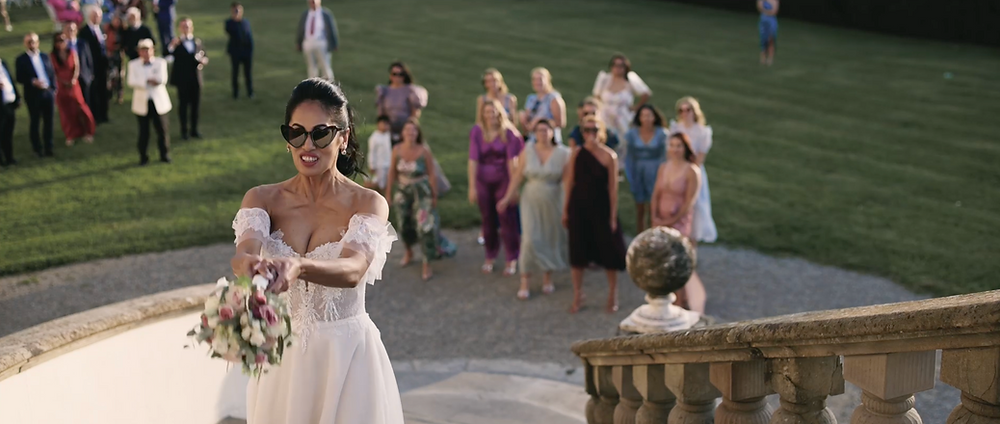 Bride throwing the bouquet on the villa staircase at Tenuta di Artimino