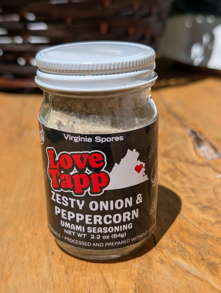 Close-up of Love Tapp seasoning showing red and black pepper blend