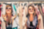 Young beautiful women at weekly cloth market - Best friends sharing free time having fun a
