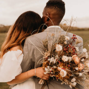 Couple Hugging with the woman holding flowers