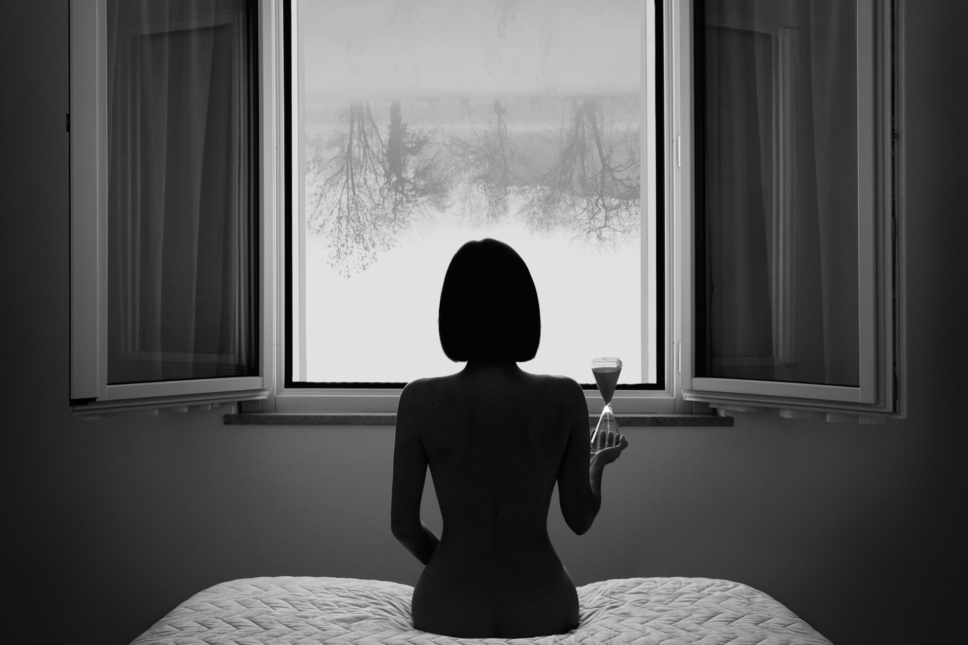 Award Winning black and white fine art surreal photography, a lonely girl in front of the window. Fine art self-portrait