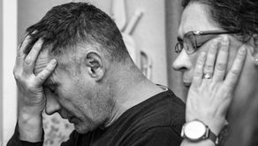 Black-and-white photo of a couple sitting apart after a conflict, reflecting emotional distance and relationship tension.