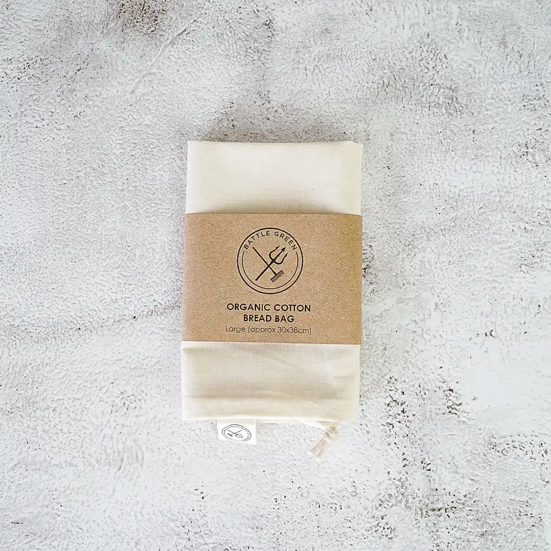 A reusable organic cotton bread bag with recycled cardboard band