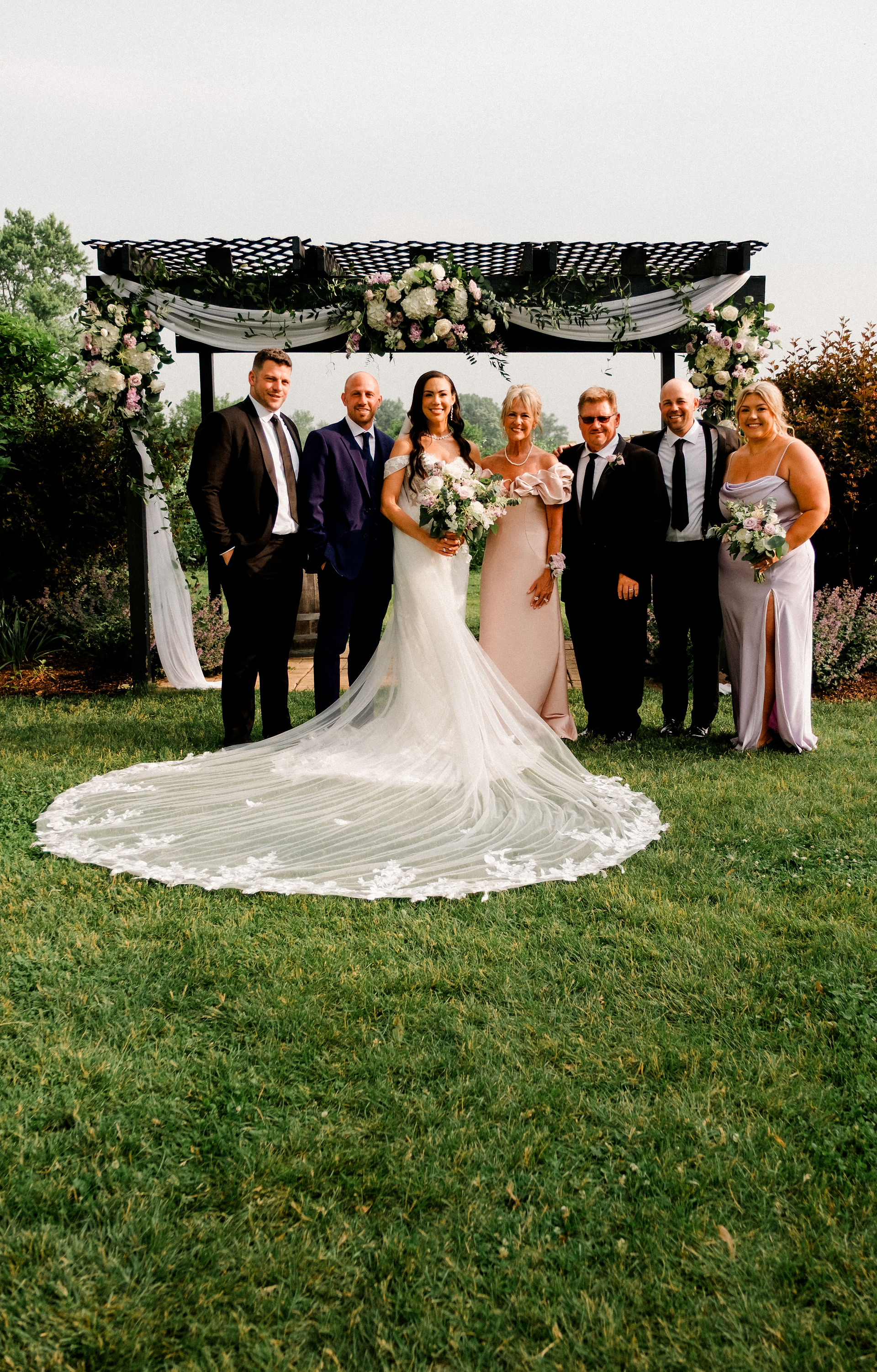 Bridal Family photo in a green outdoor setting