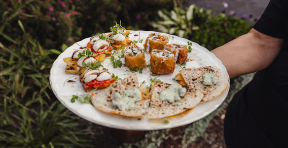 A round plate full of three different appetizers
