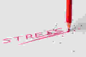 Image of pencil writing "stress" in red ink