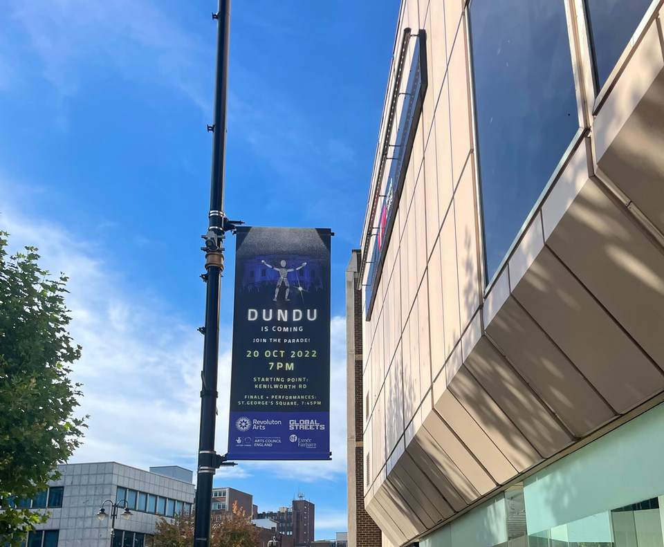 Dundu Giants Of Light Banner Outside Luton Mall
