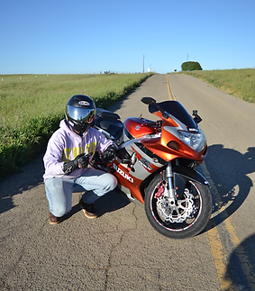 male with helmet next to motorcycle