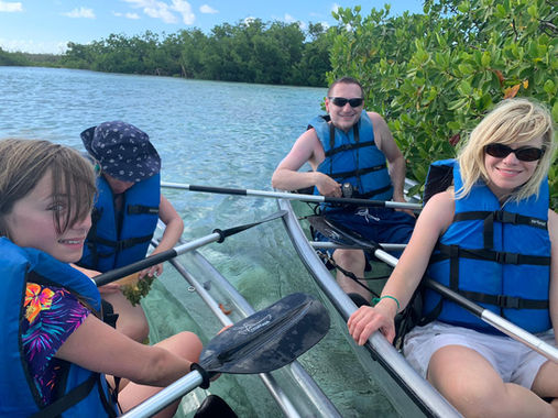 Family on a guided clear kayak tour