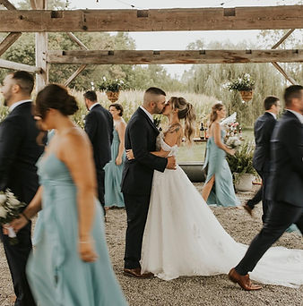 Wedding guests socializing and enjoying drinks during outdoor cocktail hour at Barn Swallow Farm in Northampton, Pennsylvania