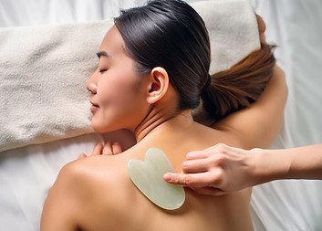 Firefly woman lie down on a bed, Gua Sha body treatment on her back. 49791_re.jpeg