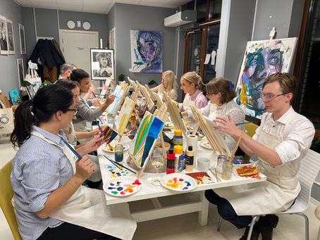 team of lawyers painting together at their team building paint party