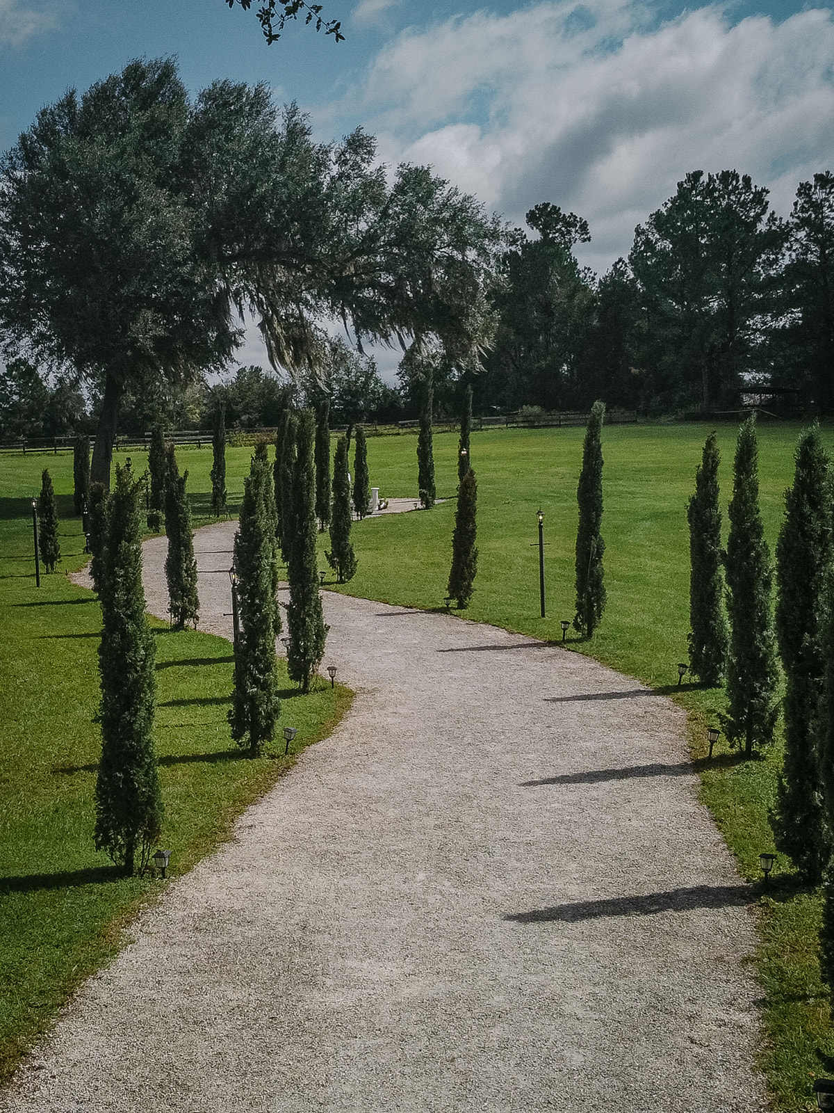 Tuscan Path lined with greenery and lemon trees at Andalusian Oaks