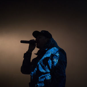 An artist on stage rapping / singing.