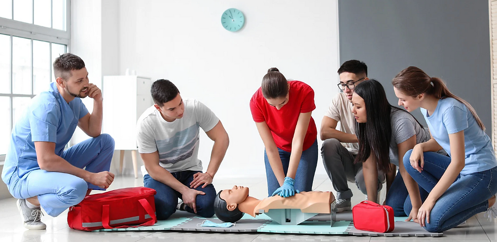 Landscape CPR training class with instructor demonstrating chest compressions on a manikin surrounded by students