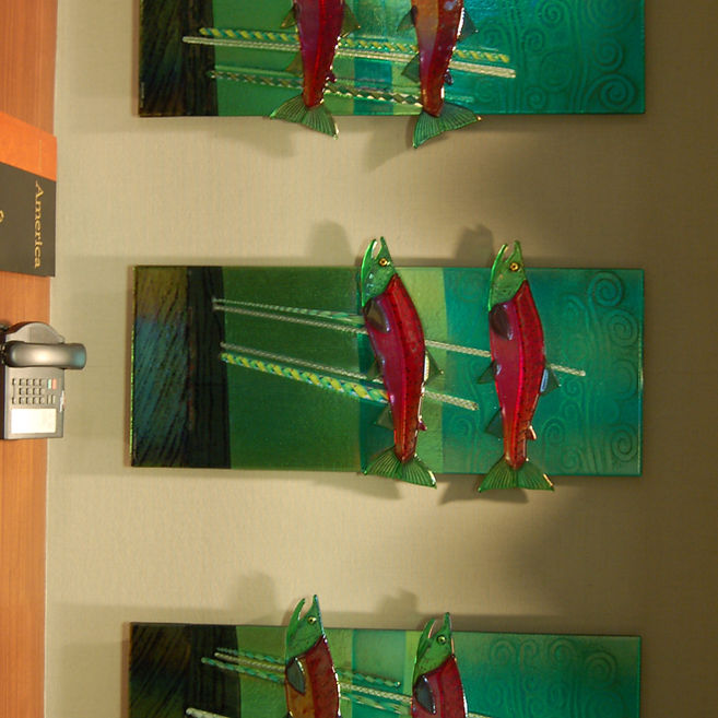 Salmon Glass Art Fused glass wall installation with vertical panels in corporate interior space