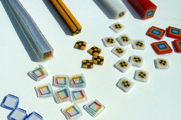 An assortment of colorful murrini that are used in cross section to decorate glass panels