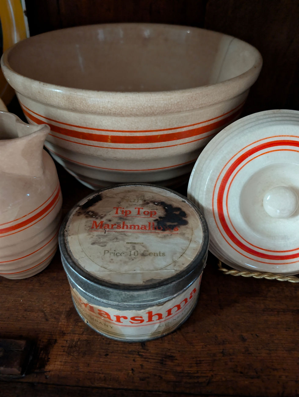 Vintage red orange stripe Hull Pottery kitchenware displayed with Tip Top Marshmallows tin