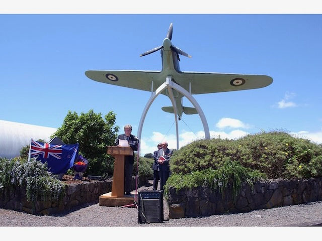 Brian Cox speaking in front of memorial