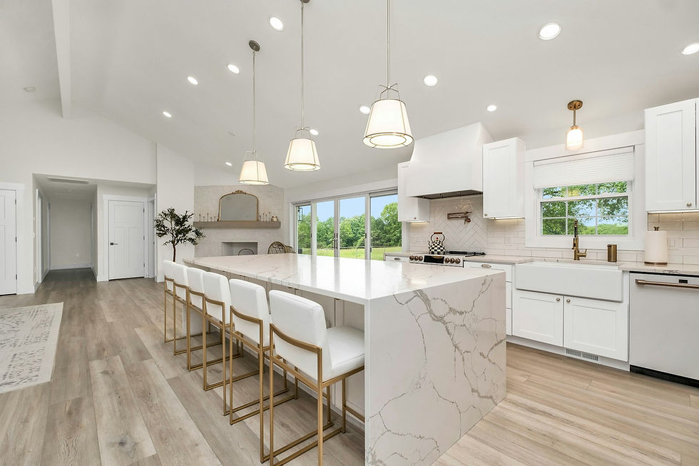 Open floor plan kitchen with large marble island and seating in a Houston home