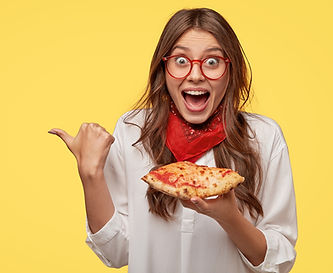 pleased-happy-young-woman-gazes-with-happiness-points-with-thumb-aside-free-space-eats-piz