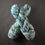 Thumbnail: Two skeins of hand-dyed yarn on an ice-white base with fjord blue and teal speckles and navy accents.