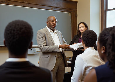 need_jamaican_professor_giving_lecture_to_government_workers_in_a_university_classroom_mor