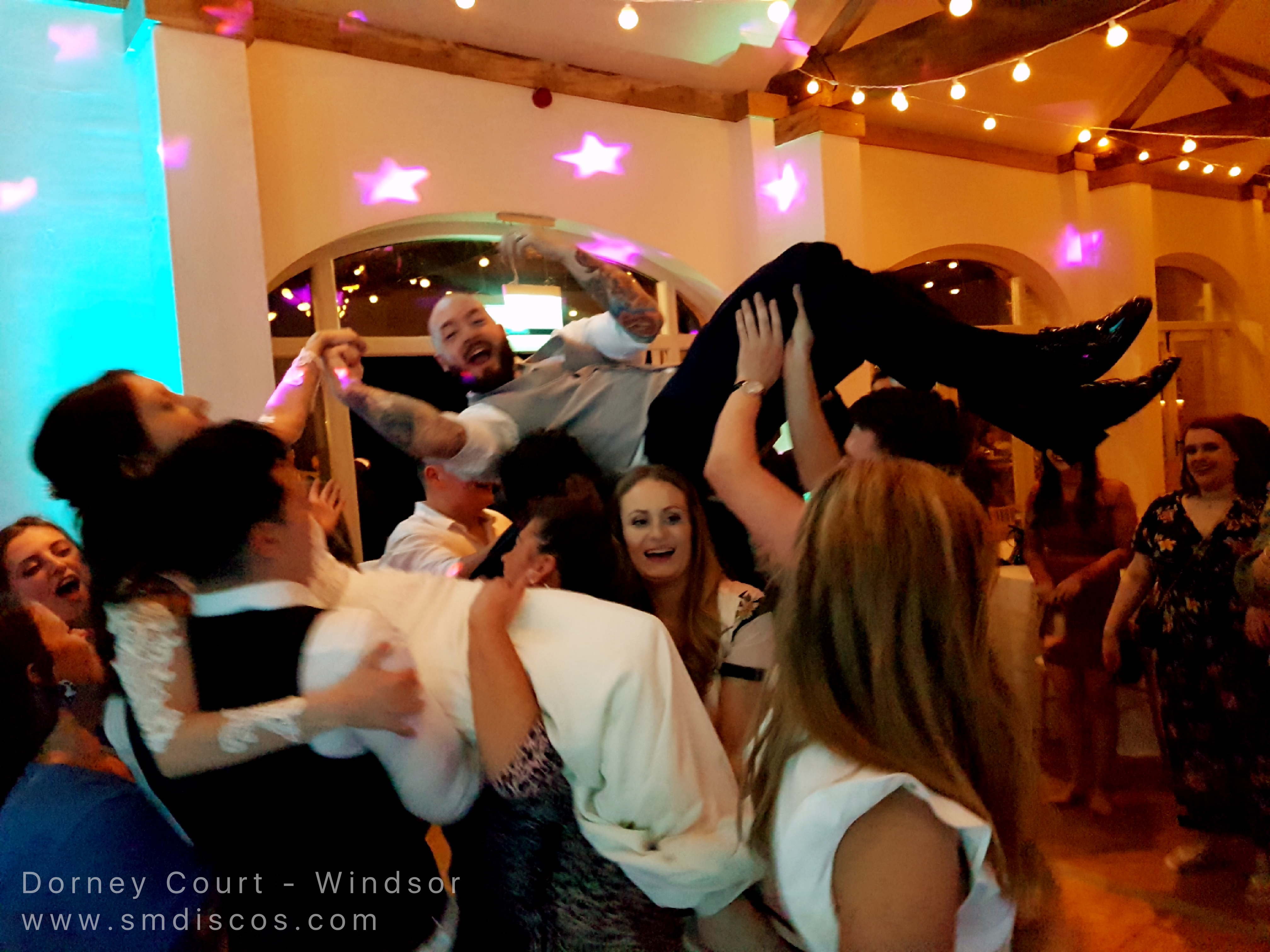 crowd surfing bride and groom