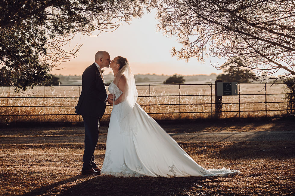 Eye-level view of a bride and groom sharing a quiet moment during sunset