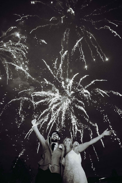 Bride and Groom celebrating in front of a firework display at Vaulty Manor.