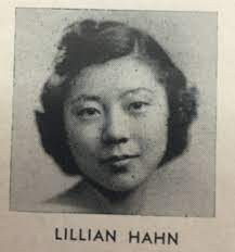 A black and white photo of young Lillian Hahn Skinner. She has short hair that is pulled up. She slightly smiles. Underneath the photo is "Lillian Hahn"