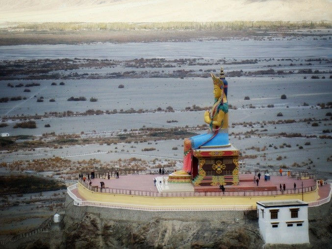 A larger than life statue of the Buddha in Diskit Monastery. In perspective, people look like ants in front of this statue.