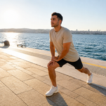 Man stretching out by water.