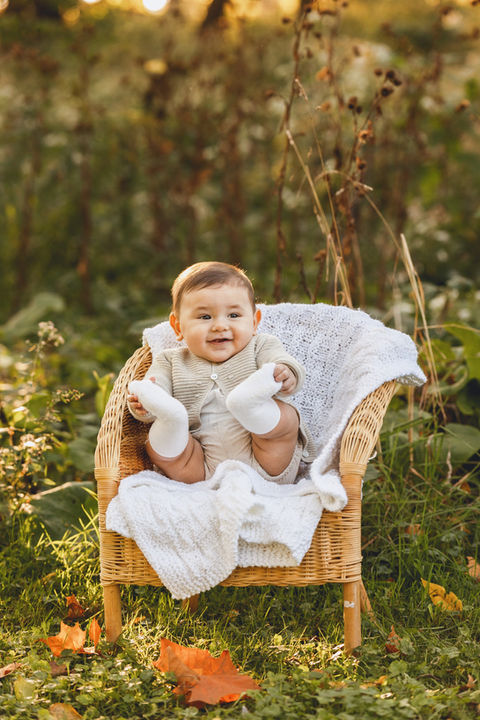 1 year old portrait in the fall with baby sitting in a tiny chair