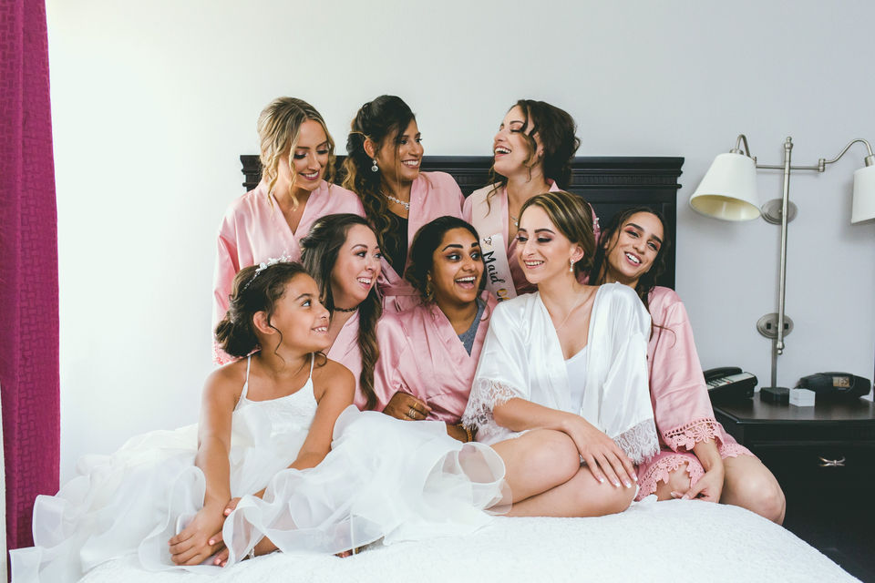 Professional wedding photography. Bridesmaids having fun and in robes. 