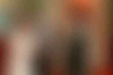 Groom wiping away tear during wedding ceremony