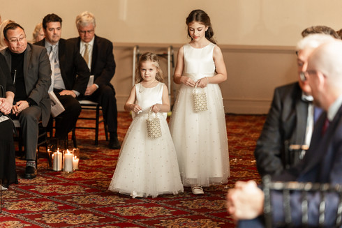 flower girls walking down an aisle