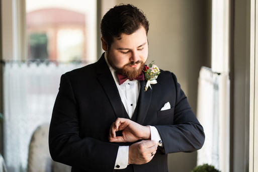 groom fixing his cufflinks