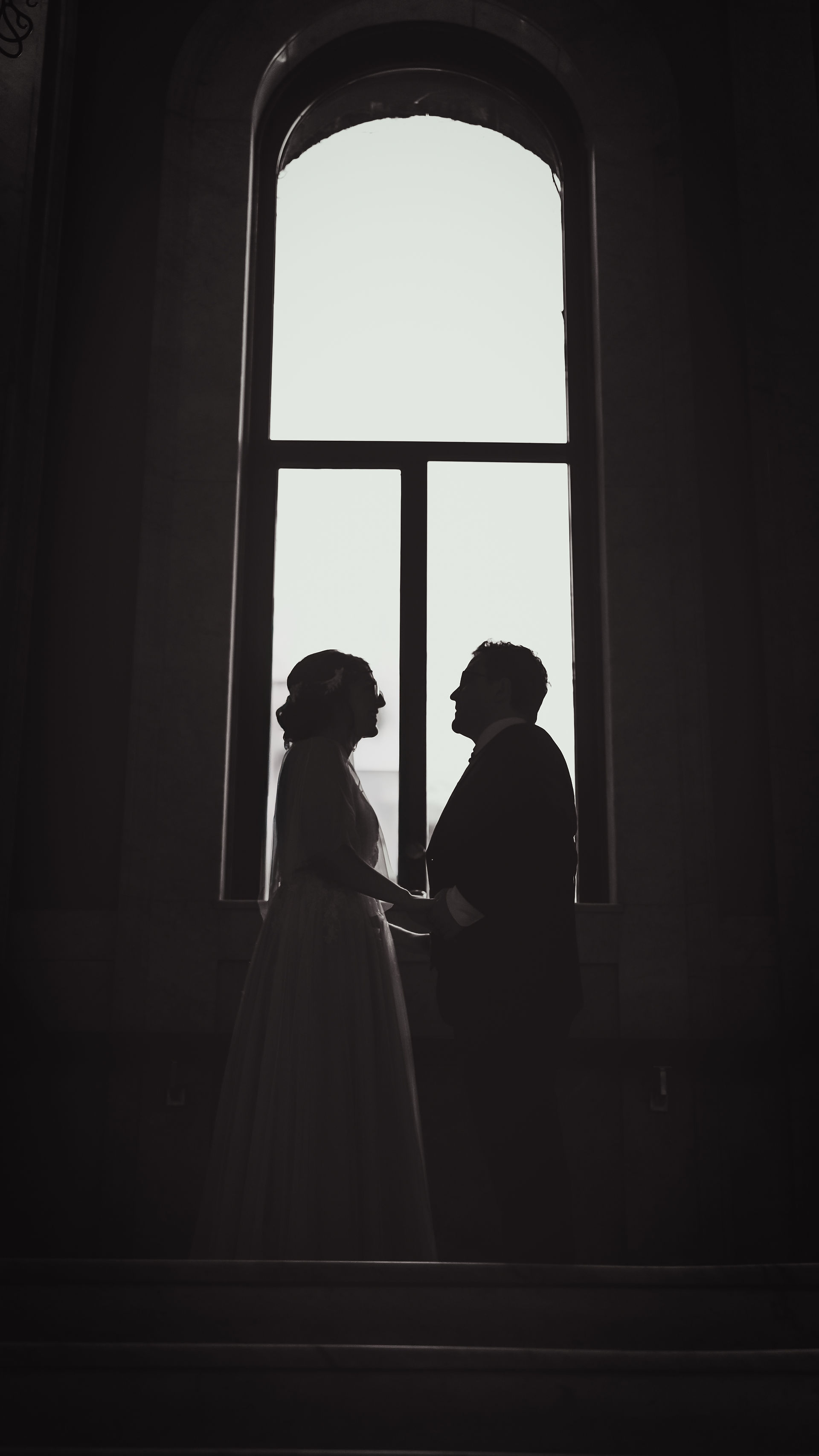 Black and white silhouette under large arch window at Newberry library