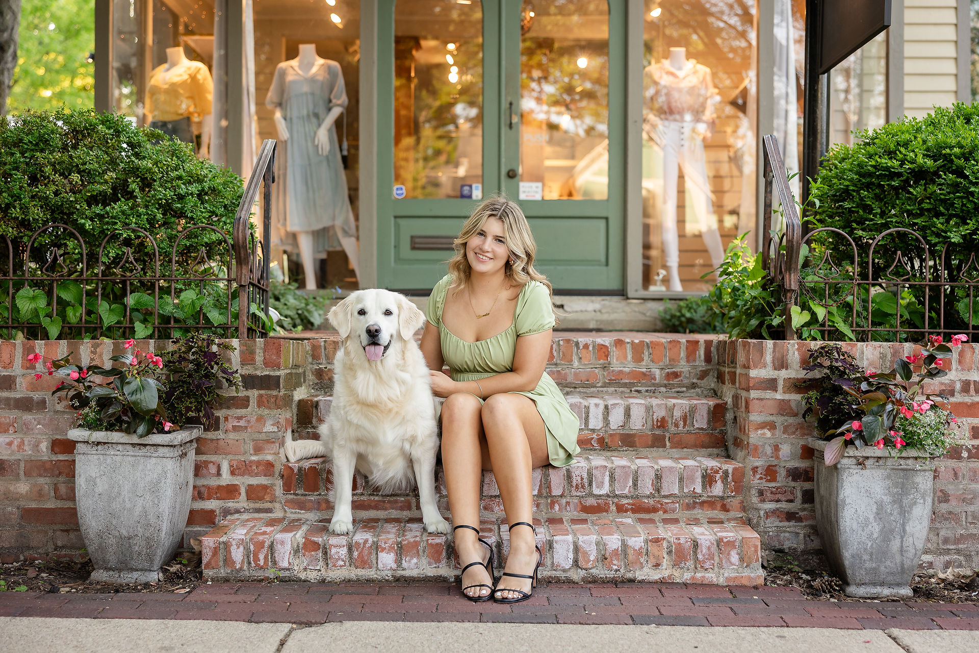 Senior session with female subject sitting on stairs with her big fluffy white dog