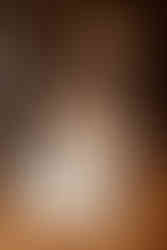 Groom twirling bride during first dance as her veil falls off