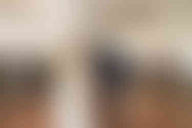 Bride and groom first dance under white tent with string lights