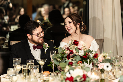 bride and groom reacting to speeches at head table