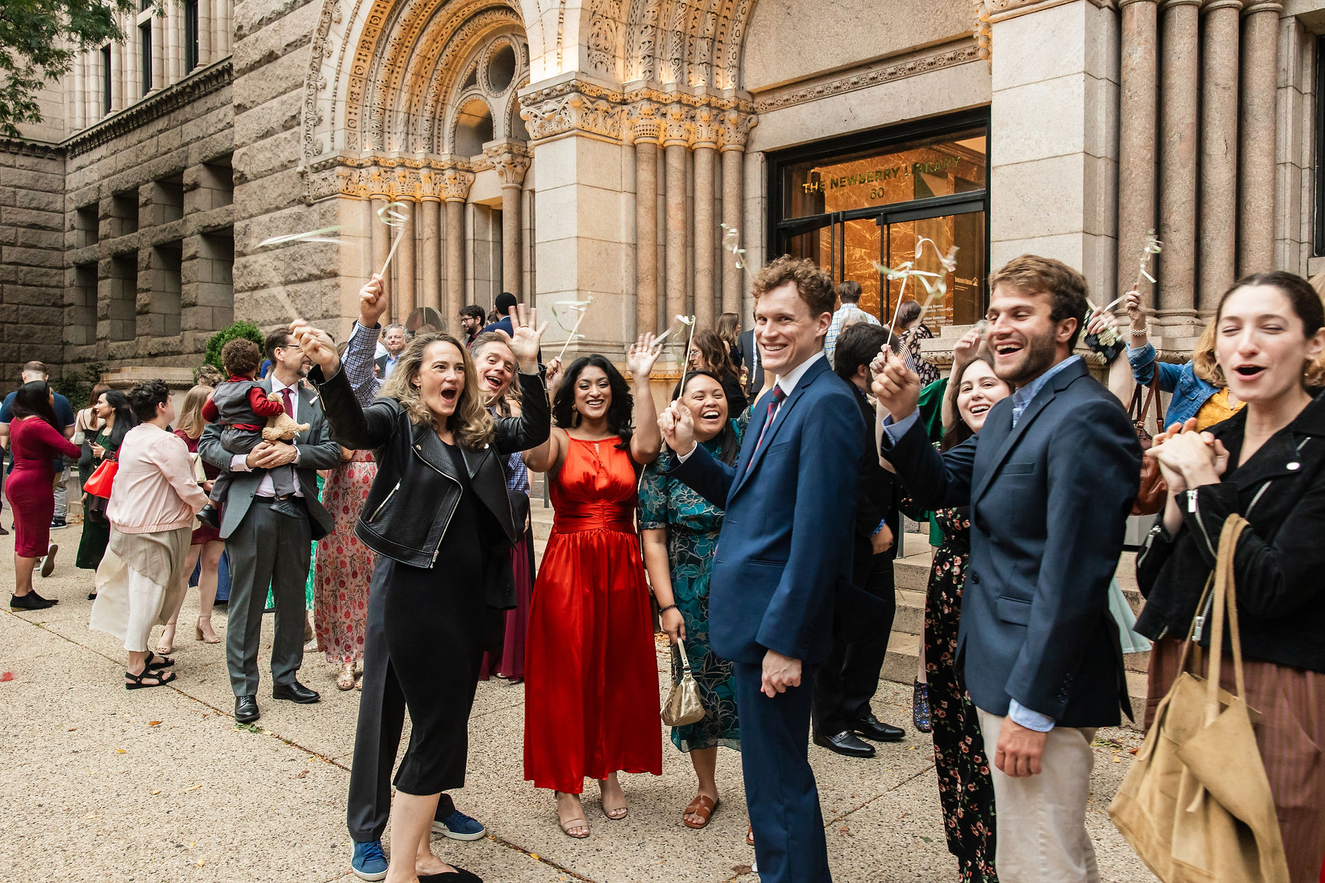 Wedding guests cheering for bride and groom