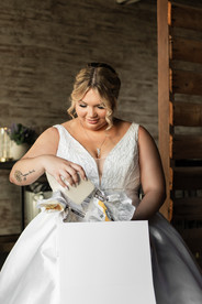 Bride opening gift from groom