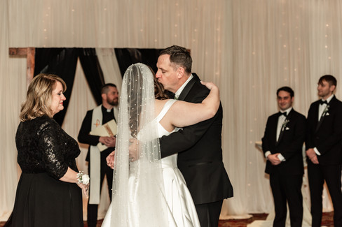 brides dad hugging her before the wedding ceremony